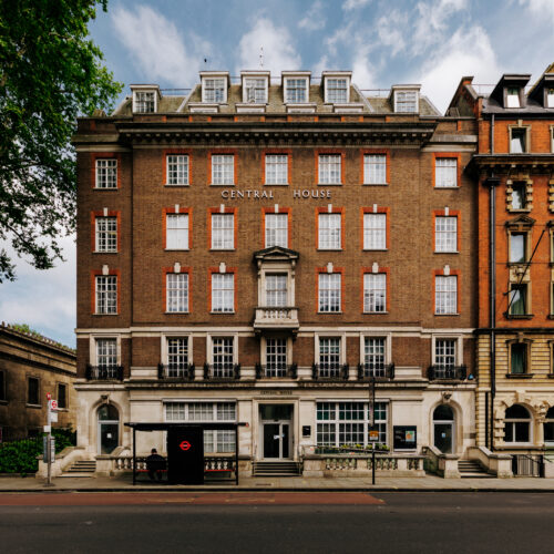 UCL Central House in Bloomsbury, London, photographed on a cloudy yet bright day, right at the moment when the sun is just breaking through the clouds and its light is still soft yet directional.